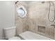 Bright bathroom with tiled shower, decorative window and neutral finishes at 635 N Yale Dr, Gilbert, AZ 85234