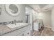 Bright bathroom featuring dual sinks, granite countertops, and wood-look floors at 635 N Yale Dr, Gilbert, AZ 85234
