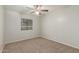 Neutral bedroom featuring a ceiling fan and bright window at 635 N Yale Dr, Gilbert, AZ 85234