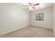 Neutral bedroom featuring a ceiling fan and bright window at 635 N Yale Dr, Gilbert, AZ 85234