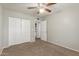 Neutral bedroom featuring a ceiling fan and ample closet space at 635 N Yale Dr, Gilbert, AZ 85234