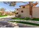 Side view of stucco house featuring terracotta roof, well manicured yard and mature shade trees at 635 N Yale Dr, Gilbert, AZ 85234