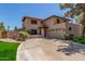 Inviting stucco home featuring a terracotta roof, landscaped yard, and attached two-car garage on a sunny day at 635 N Yale Dr, Gilbert, AZ 85234
