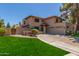 Beautiful two-story home featuring a lush green lawn, mature trees, and a two-car garage at 635 N Yale Dr, Gilbert, AZ 85234