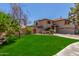 Charming two-story home with a well-manicured lawn and a terracotta tile roof at 635 N Yale Dr, Gilbert, AZ 85234