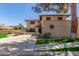 Two-story home featuring a terracotta roof, decorative wall, and desert landscaping at 635 N Yale Dr, Gilbert, AZ 85234