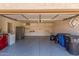 Spacious two-car garage with ample storage, shelving, and gray epoxy flooring at 635 N Yale Dr, Gilbert, AZ 85234