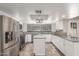 Updated kitchen with white cabinetry, stainless steel appliances, and tile backsplash at 635 N Yale Dr, Gilbert, AZ 85234