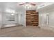 Spacious living room with wood feature wall, ceiling fan, and wood-style tile at 635 N Yale Dr, Gilbert, AZ 85234