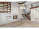 Living room with whitewashed brick fireplace, open staircase, and vaulted ceiling at 635 N Yale Dr, Gilbert, AZ 85234