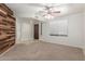 Cozy living room with wood accent wall, ceiling fan, and lots of natural light at 635 N Yale Dr, Gilbert, AZ 85234