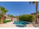 A serene backyard pool is surrounded by lush palm trees and landscaping, creating a private oasis at 635 N Yale Dr, Gilbert, AZ 85234