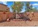 Charming backyard featuring a custom rock waterfall, desert landscaping and decorative art features at 6469 W Ruth Ave, Glendale, AZ 85302