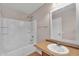Bathroom features a bathtub with shower head and a vanity with white sink and a decorative framed mirror at 6469 W Ruth Ave, Glendale, AZ 85302