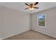 Carpeted bedroom features a window and fan overhead with neutral-color walls creating a clean space at 6469 W Ruth Ave, Glendale, AZ 85302