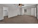 Large carpeted bedroom with ceiling fan, a walk-in closet, and ample natural light at 6469 W Ruth Ave, Glendale, AZ 85302
