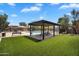 Community area featuring a shaded pergola with seating and a view of the sparkling pool at 6469 W Ruth Ave, Glendale, AZ 85302