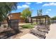 Inviting community area with a shaded lounge, manicured grass, and comfortable chaise lounges at 6469 W Ruth Ave, Glendale, AZ 85302