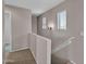 Upstairs hallway featuring carpeted floors, natural lighting, and access to rooms at 6469 W Ruth Ave, Glendale, AZ 85302