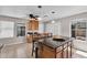 Kitchen island with granite countertop, pendant lighting and seating for a casual dining experience at 6469 W Ruth Ave, Glendale, AZ 85302
