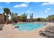Community pool surrounded by lounge chairs and shaded ramadas in a well-maintained area at 6469 W Ruth Ave, Glendale, AZ 85302