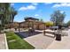Community pool area with a covered picnic pavilion, artificial turf, and lounge chairs at 6469 W Ruth Ave, Glendale, AZ 85302