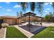 Community pool area with a covered picnic pavilion, artificial turf, and lounge chairs at 6469 W Ruth Ave, Glendale, AZ 85302