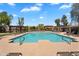 Community pool surrounded by lounge chairs and shaded ramadas in a well-maintained area at 6469 W Ruth Ave, Glendale, AZ 85302