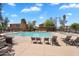 Community pool surrounded by lounge chairs and shaded ramadas in a well-maintained area at 6469 W Ruth Ave, Glendale, AZ 85302