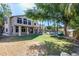 Expansive backyard with lush lawn, mature trees, covered patio, and sparkling swimming pool with rock waterfall feature at 7217 S Hazelton Ln, Tempe, AZ 85283