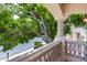 Balcony with stucco columns overlooking street and lush green trees at 7217 S Hazelton Ln, Tempe, AZ 85283