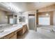 Bright primary bathroom with dual sinks, vanity and separate tub with shower at 7217 S Hazelton Ln, Tempe, AZ 85283