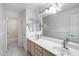 Bright bathroom with a dual sink vanity, a large mirror, and decorative lighting at 7217 S Hazelton Ln, Tempe, AZ 85283