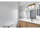 Bathroom with light wood cabinets, large mirror, and white toilet at 7217 S Hazelton Ln, Tempe, AZ 85283