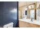 Bathroom featuring a modern vanity, decorative mirror, and fresh paint at 7217 S Hazelton Ln, Tempe, AZ 85283