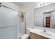 Bathroom featuring a shower with glass doors, toilet, and single sink vanity at 7217 S Hazelton Ln, Tempe, AZ 85283