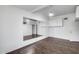 Bedroom with wood floors, mirrored wall, and white storage cabinets at 7217 S Hazelton Ln, Tempe, AZ 85283