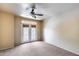 A room with neutral colors, large windows, and a ceiling fan at 7217 S Hazelton Ln, Tempe, AZ 85283