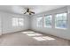 Spacious bedroom illuminated by natural light through large windows and a ceiling fan at 7217 S Hazelton Ln, Tempe, AZ 85283
