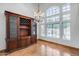 Elegant dining room with a grand chandelier, custom hutch, and views of the sparkling backyard pool at 7217 S Hazelton Ln, Tempe, AZ 85283