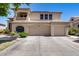 Charming two-story home with a three-car garage and a beautiful balcony under clear blue sky at 7217 S Hazelton Ln, Tempe, AZ 85283