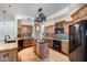 Bright kitchen featuring custom cabinetry, mosaic tile backsplash, and a center island at 7217 S Hazelton Ln, Tempe, AZ 85283
