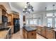 Gourmet kitchen with a central island, breakfast nook, wooden cabinets, and black appliances at 7217 S Hazelton Ln, Tempe, AZ 85283