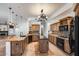 Well-appointed kitchen with island, granite countertops, custom cabinetry, and stainless steel appliances at 7217 S Hazelton Ln, Tempe, AZ 85283