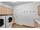 Laundry room featuring a washer and dryer, storage cabinets, and tiled floor at 7217 S Hazelton Ln, Tempe, AZ 85283