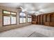 Spacious living room featuring custom wood bookcases, carpet and plantation shutters at 7217 S Hazelton Ln, Tempe, AZ 85283