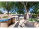 Outdoor kitchen features a grill, sink, storage, and tiled countertop, perfect for entertaining in the backyard at 7217 S Hazelton Ln, Tempe, AZ 85283