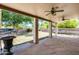 Covered patio with stone flooring overlooking a backyard with a built-in barbeque at 7217 S Hazelton Ln, Tempe, AZ 85283