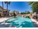 Backyard pool with a rock waterfall feature and mature landscaping, perfect for outdoor relaxation at 7217 S Hazelton Ln, Tempe, AZ 85283
