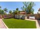This backyard features a large artificial turf area, and storage sheds at 7512 W Tonto Dr, Glendale, AZ 85308